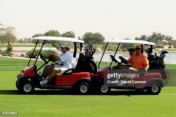 Ian Botham gives Michael Vaughan a push in his buggie after it breaks down during the Laureus World Sports Awards Golf Challenge at the Abu Dhabi...