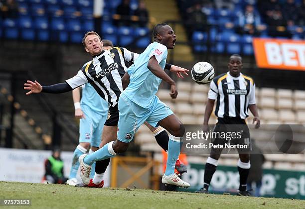 Abdul Osman of Northampton Town attempts to move away from the challenge of Sean Rigg of Port Vale during the Coca Cola League Two Match between Port...
