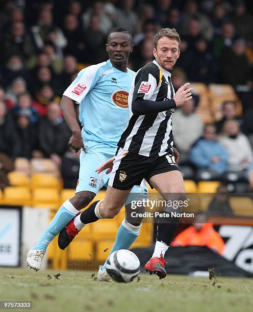 Sean Rigg of Port Vale looks for the ball with Abdul Osman of Northampton Town during the Coca Cola League Two Match between Port Vale and...