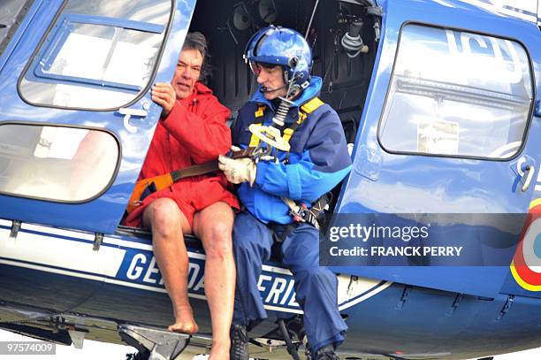 Person is being rescued by a French gendarme after being airlifted by an helicopter of the National Gendarmerie, on February 28 as a result of heavy...