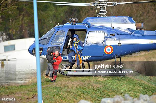 Child is being rescued by French gendarmes after being airlifted by an helicopter of the National Gendarmerie, on February 28 as a result of heavy...