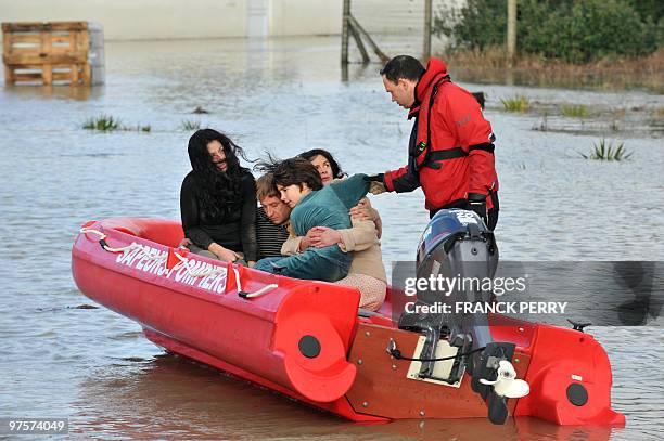 Residents are evacuated in a zodiac by firefighters, on February 28 as a result of heavy floods, in La Faute-sur-Mer western France. Dubbed...