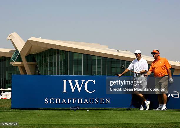 Sir Ian Botham and Michael Vaughan look down the 1st hole during the Laureus World Sports Awards Golf Challenge at the Abu Dhabi Golf Club on March...