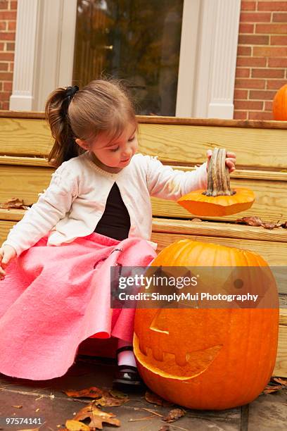 costumed child with jack-o-lantern - jack o lantern bildbanksfoton och bilder