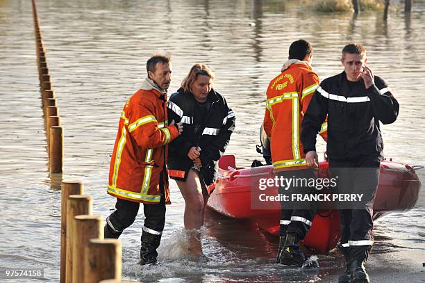 Residents are evacuated in a zodiac by firefighters, on February 28 as a result of heavy floods, in La Faute-sur-Mer western France. Dubbed...