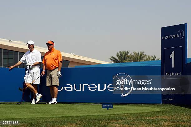 Sir Ian Botham and Michael Vaughan look down the 1st hole during the Laureus World Sports Awards Golf Challenge at the Abu Dhabi Golf Club on March...