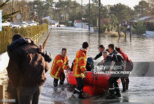 Residents are evacuated in a zodiac by firefighters, on February 28 as a result of heavy floods, in La Faute-sur-Mer western France. Dubbed...