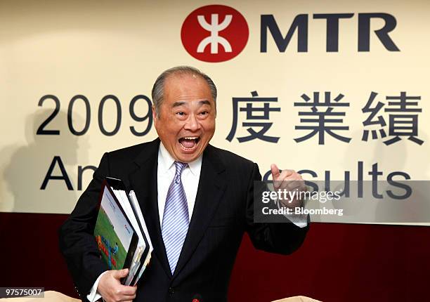 Chow Chung Kong, chief executive officer of MTR Corp., gestures as he arrives for the company's 2009 annual results news conference in Hong Kong,...