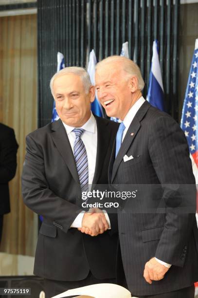 In this handout image from the Israeli Government Press Office, L - R Israeli Prime Minister Benjamin Netanyahu shakes hands with US Vice President...