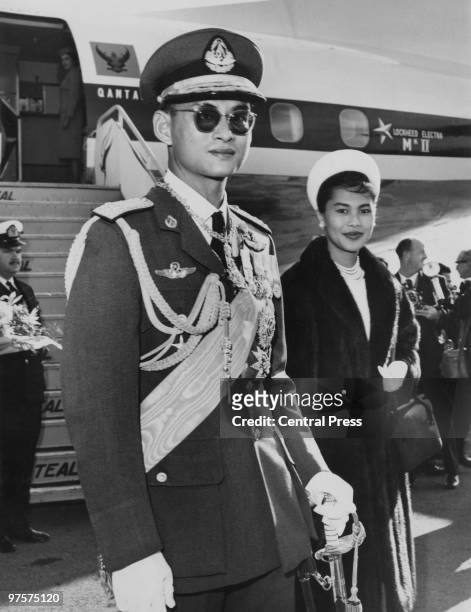 King Bhumibol and Queen Sirikit of Thailand arrive at Wellington Airport in New Zealand for an eight-day tour, August 1962. From there, they will...