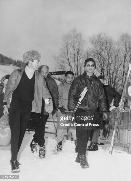 King Bhumibol of Thailand leaves his hotel for the piste during a skiing holiday in Gstaad, Switzerland, 1961. He is staying at the Palace Hotel.