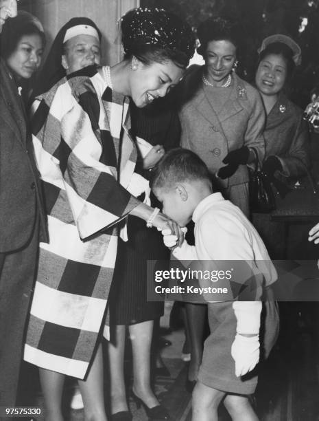 Queen Sirikit of Thailand recieves a special welcome from a little boy at the Cesare Battisti Children's Institute run by the Italian Red Cross in...