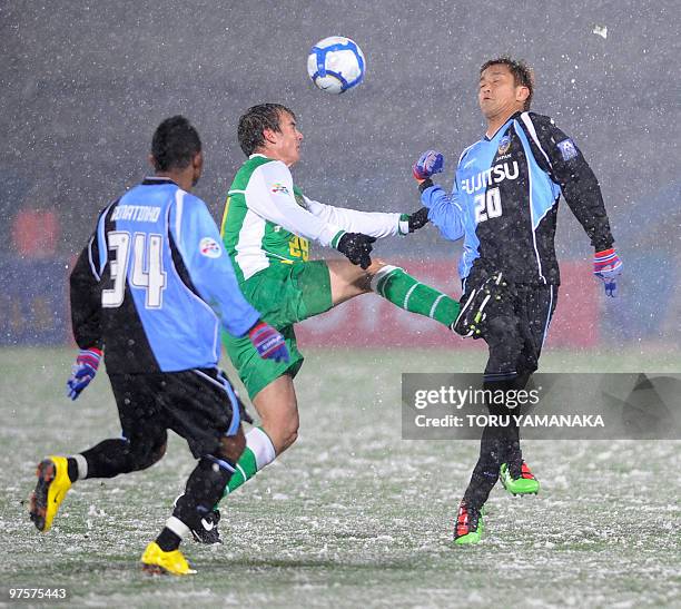 China's Beijing Guoan forward Griffiths Joel battles for the ball between Japanese club Kawasaki Frontale midfielder Junichi Inamoto and forward...