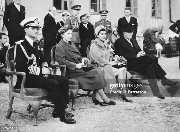 King Bhumibol and Queen Sirikit of Thailand watch a performance by Swedish folk dancers at Skansen, a zoological garden in Stockholm, during a state...