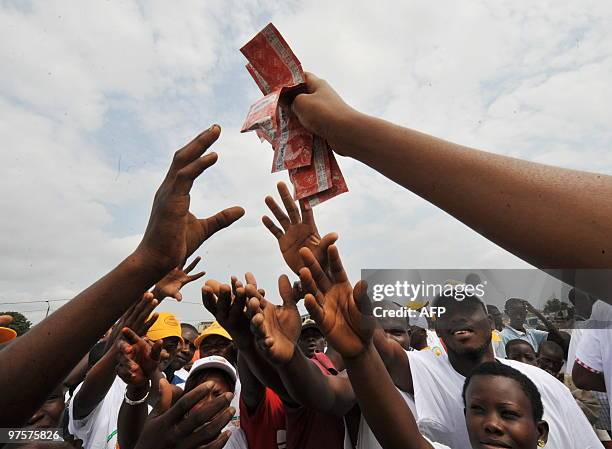 Young woman hands over condoms in Yopougon, a working district of the capital city Abidjan on September 28 as part of an AIDS prevention programme...