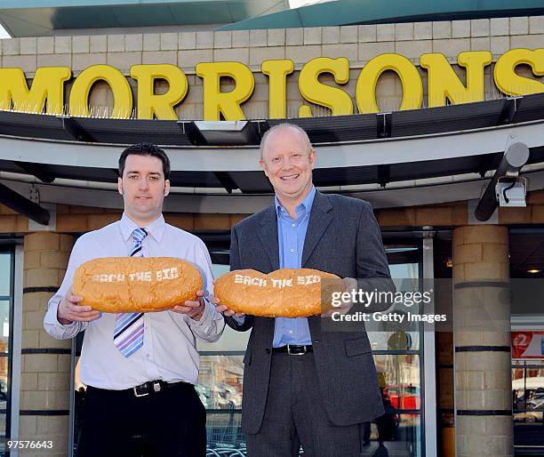 Former England footballer Mark Wright and Jason Nicholson, deputy store manager, pose during a photo call to promote Morrisons as a sponsor of the...