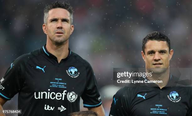 Kevin Pietersen and Dan Carter line up during the Soccer Aid for UNICEF 2018 match between England and The Rest of the World at Old Trafford on June...