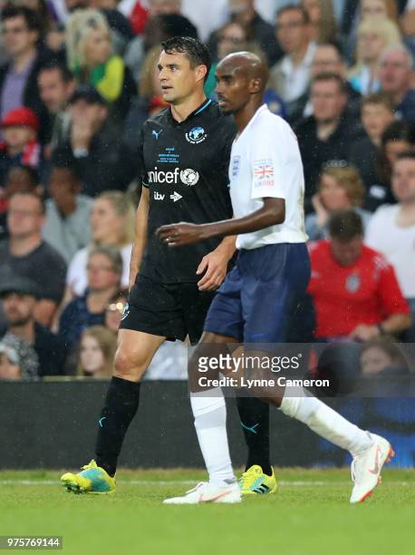 Sir Mo Farah and Dan Carter talk during the Soccer Aid for UNICEF 2018 match between England and The Rest of the World at Old Trafford on June 10,...