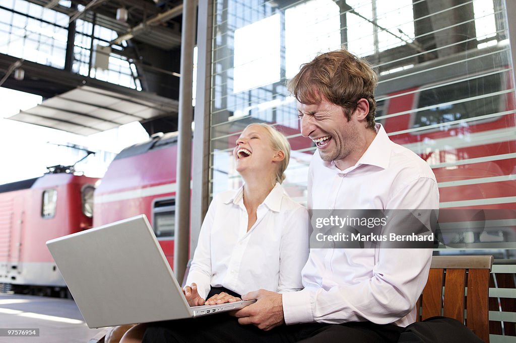 2 business colleagues laughing.