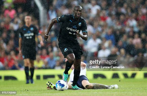 Damian Lewis and Yaya Toure fight for the ball during the Soccer Aid for UNICEF 2018 match between England and The Rest of the World at Old Trafford...