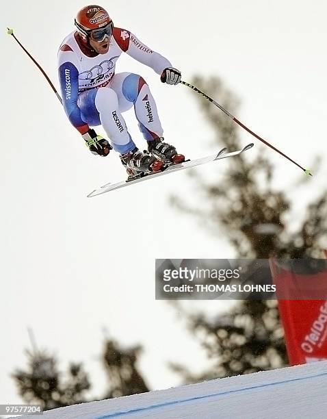 Switzerland's Didier Cuche jumps during the Men's Downhill at the Alpine skiing World Cup in Garmisch Partenkirchen, southern Germany on March ,...