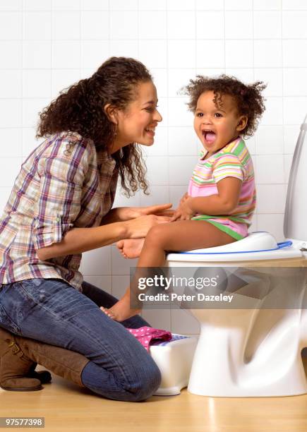 hispanic mother and daughter toilet training - girls peeing stock pictures, royalty-free photos & images