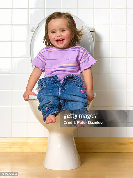 toddler sitting on toilet training seat - girls peeing stock pictures, royalty-free photos & images