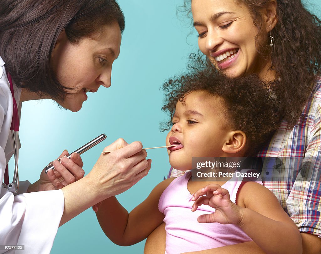 Doctor with Hispanic mother and daughter