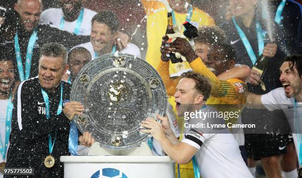 Robbie Williams and Olly Murs lift the trophy after winning the Soccer Aid for UNICEF 2018 match between England and The Rest of the World at Old...