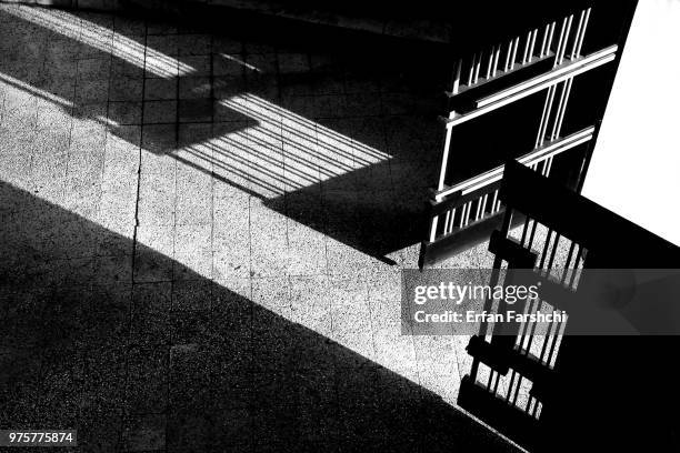 open gate casting long shadow - driveway gate stock pictures, royalty-free photos & images