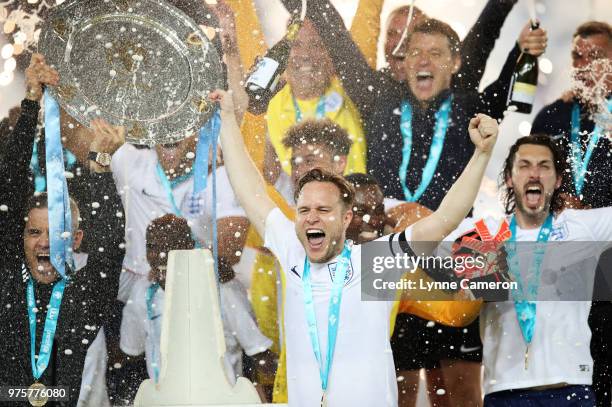 Robbie Williams and Olly Murs lift the trophy after winning the Soccer Aid for UNICEF 2018 match between England and The Rest of the World at Old...
