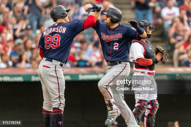 Logan Morrison celebrates with Brian Dozier of the Minnesota Twins after both scored on a home run by Dozier during the fourth inning against the...