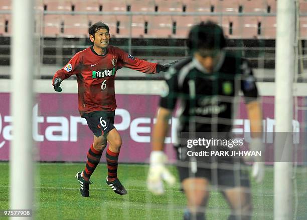 Nakata Koji of Japan's Kashima Antlers celebrates his goal as South Korea's Jeonbuk Motors goalkeeper Kwoun Sun-Tae reacts during a preliminary Group...