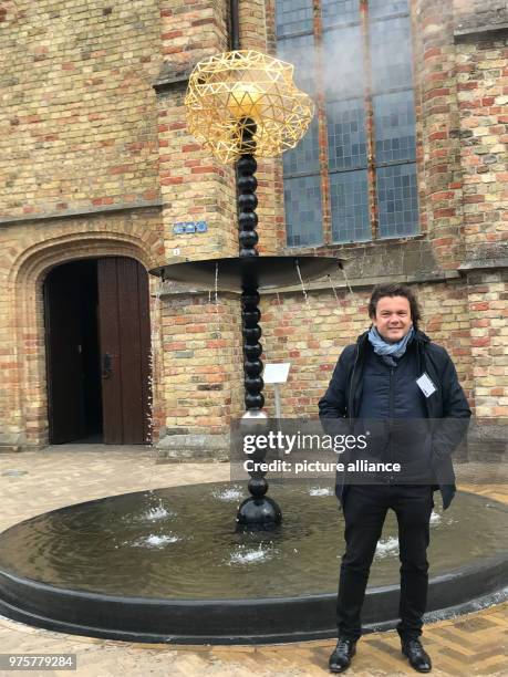 May 2018, Netherlands, Franeker: French artist Jean-Michel Othoniel standing in front of his fountain "Die Wolke von Oort" . Friesland has 11...
