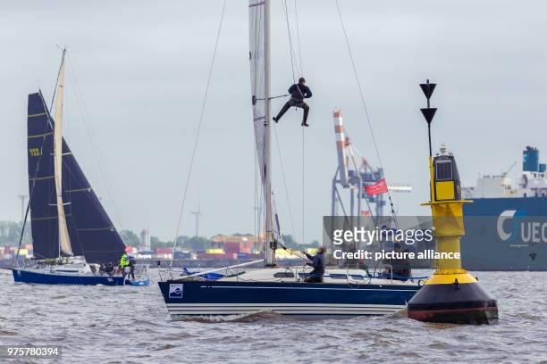 May 2018, Germany, Cuxhaven: Sailing crew prepare their boats on the estuary of the Elb river for the sailing race heading for Heligoland. The North...