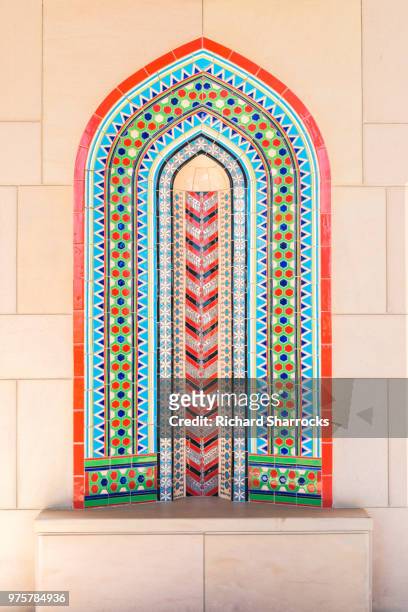 seating area with intricate tiling, sultan qaboos grand mosque, muscat, oman - sultan qaboos grand mosque ストックフォトと画像
