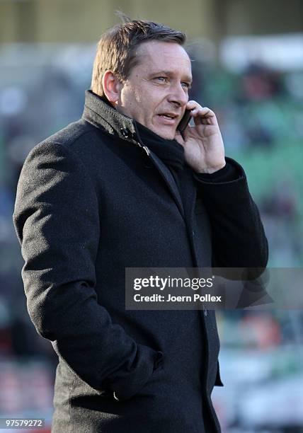 Manager Horst Heldt of Stuttgart is seen with a cellphone prior to the Bundesliga match between Werder Bremen and VfB Stuttgart at Weser Stadium on...