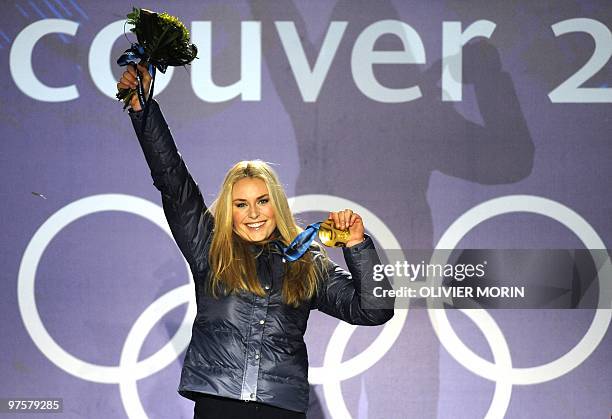 Gold medallist Lindsey Vonn stands on the podium during the medal ceremony for the Alpine skiing Ladies downhill event of the Vancouver 2010 Winter...