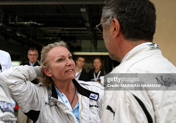 German TV presenter Sabine Christiansen speaks to her husband Norbert Medus at the Laureus World Sports Awards driving experience event at Yas Marina...