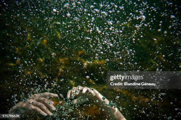 hands of man drowning in water - drowning stock-fotos und bilder