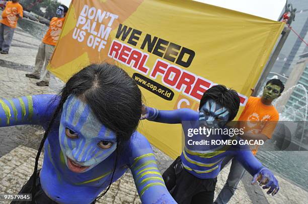 Indonesian environmental activists from the Centre for Orangutan Protection perform during a campaign entitled "orangutans need forests, not palm oil...