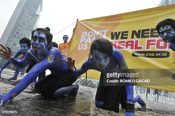Indonesian environmental activists from the Centre for Orangutan Protection perform during a campaign entitled "orangutans need forests, not palm oil...