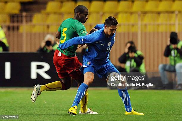 Marco Borriello of Italy holds off the challenge by Sebastien Bassong of Cameroon during the International Friendly match between Italy and Cameroon...