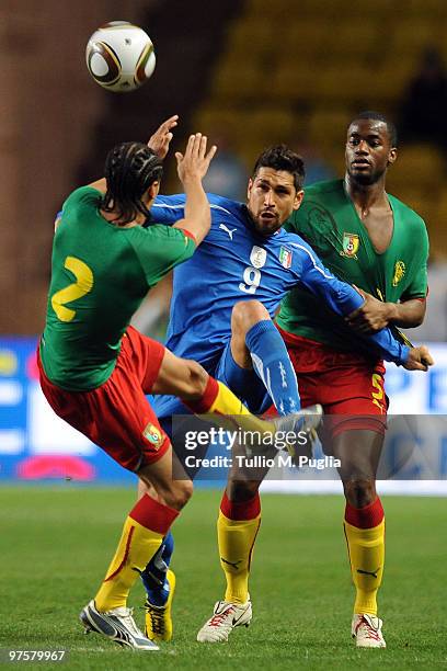 Marco Borriello of Italy is challenged by Benoit Assou Ekotto and Sebastien Bassong of Cameroon during the International Friendly match between Italy...