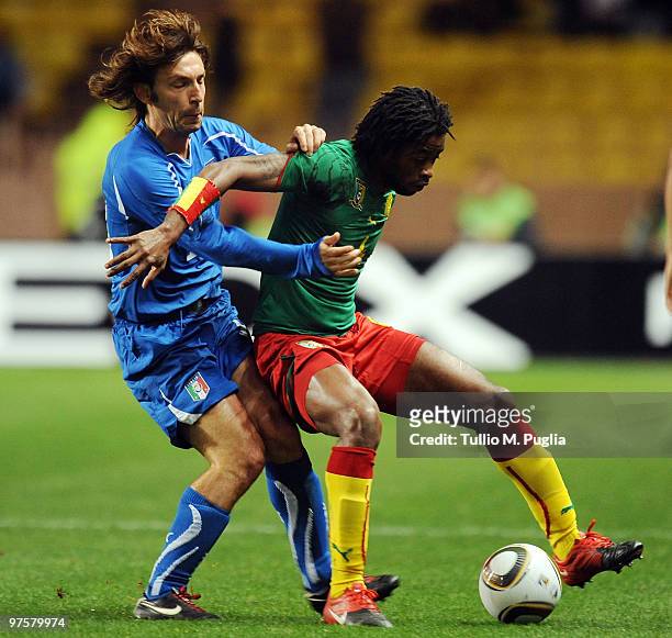 Alexandre Song of Cameroon is challenged by Andrea Pirlo of Italy during the International Friendly match between Italy and Cameroon at Louis II...