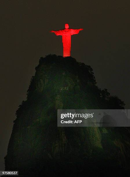 Rio de Janeiro's landmark, Christ, the Redeemer statue overlooking the Rodrigo de Freitas lagoon, appears lit in red to celebrate the World AIDS Day,...