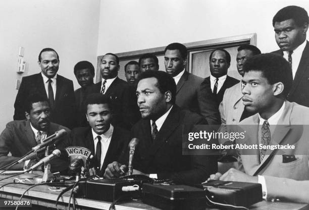 Group of top African American athletes from different sporting disciplines gather to give support and hear the boxer Muhammad Ali give his reasons...