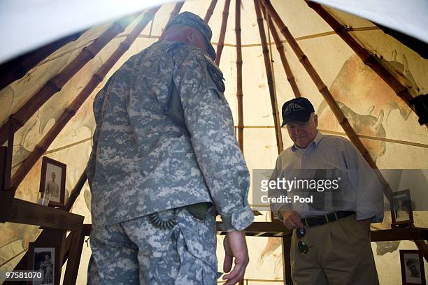 Secretary of Defence Robert Gates takes a moment as he looks over the 21 memorial within the Stryker Tepee Memorial while visiting US Army troops of...