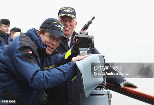 German Defense Minister Karl-Theodor zu Guttenberg looks through a telescope during his inaugural visit aboard the FGS Mecklenburg Vorpommern Navy...