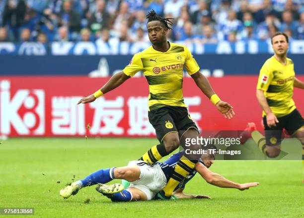 Michy Batshuayi of Dortmund and Benjamin Stambouli of Schalke battle for the ball during the Bundesliga match between FC Schalke 04 and Borussia...
